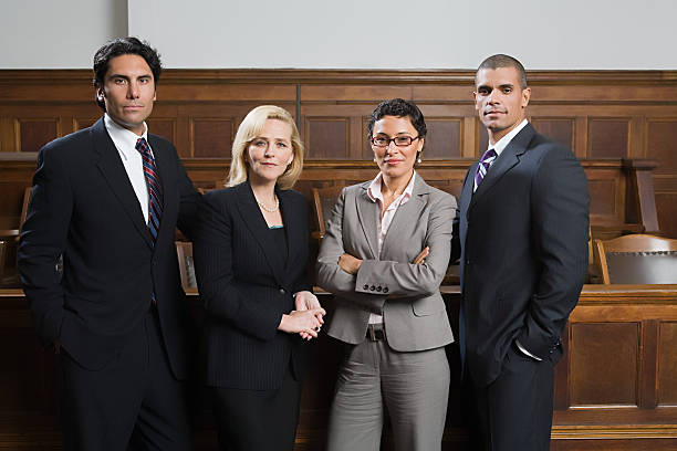 Professional legal team standing prepared in a courtroom setting